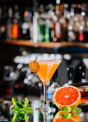 Vibrant grapefruit cocktail in a martini glass, perfect for summer parties or elegant gatherings