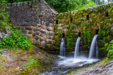 Waterfall in the forest. Mountain river in the forest. Beautiful waterfall in the forest.