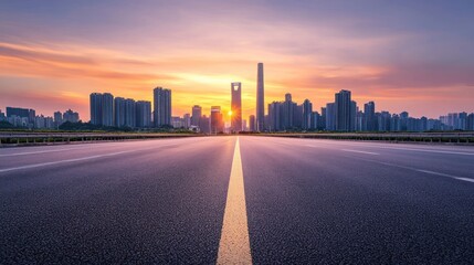 Fototapeta premium Empty Road Leading to a City Skyline at Sunset