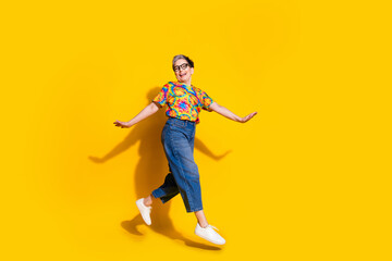 Fototapeta na wymiar Full size profile photo of nice aged lady jump run empty space wear t-shirt isolated on yellow color background