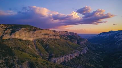 Fototapeta premium Dramatic golden light paints Arizona's canyon landscape as the sun dips below majestic mountain peaks