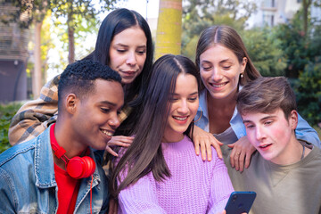 Fototapeta premium Five students having fun with mobile phones creating content on social media.