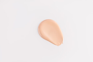 A beautiful sample of foundation powder on a white background. A copy of the space. Upper view. pattern, beige tone texture layout.