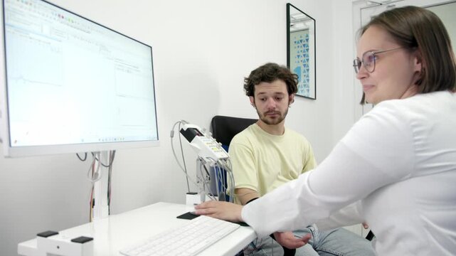 The patient undergoes an electromyography (EMG) test to assess nerve activity. Detects nerve and muscle dysfunctions. Perfect for showcasing advanced medical technologies