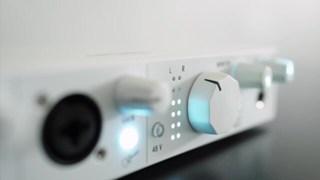 Audio signal output level indicator on a front panel of an audio interface. Close up