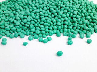 Sea green masterbatch granules on white background. Color pigment carrier polymer in plastic industry