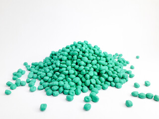 Sea green masterbatch granules on white background. Color pigment carrier polymer in plastic industry
