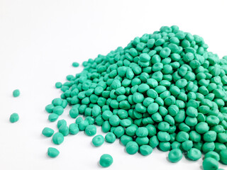 Sea green masterbatch granules on white background. Color pigment carrier polymer in plastic...