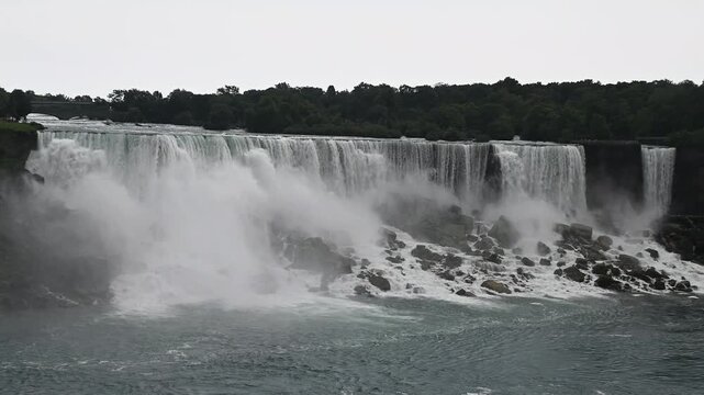 Niagara falls American falls view in cloudy weather from Ontario Canada.  