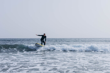  young guy surfers going for surfing in the ocean.