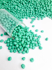 Sea green masterbatch granules on white background. Color pigment carrier polymer in plastic industry