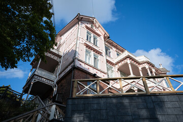 low angle of a beautiful pink house in Helsinki, Finland. In this northern european country you can find this huge old building that is perfectly preserved. The classic architecture 