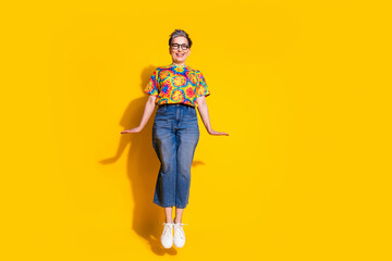 Fototapeta premium Full size photo of nice aged lady jump empty space wear t-shirt isolated on yellow color background