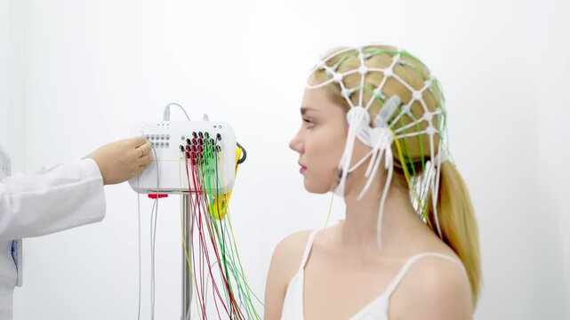 A young woman undergoes an EEG test in a modern clinic, showcasing advanced medical technology and patient care. Ideal for highlighting modern diagnostic procedures and healthcare innovations.