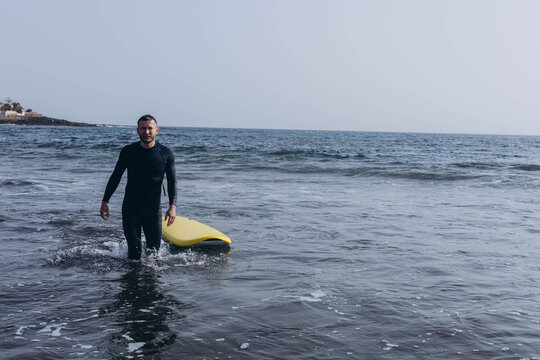  young guy surfers going for surfing in the ocean.