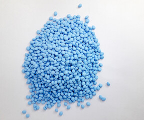 Serene sky blue masterbatch granules on white background. Color pigment carrier polymer in plastic industry