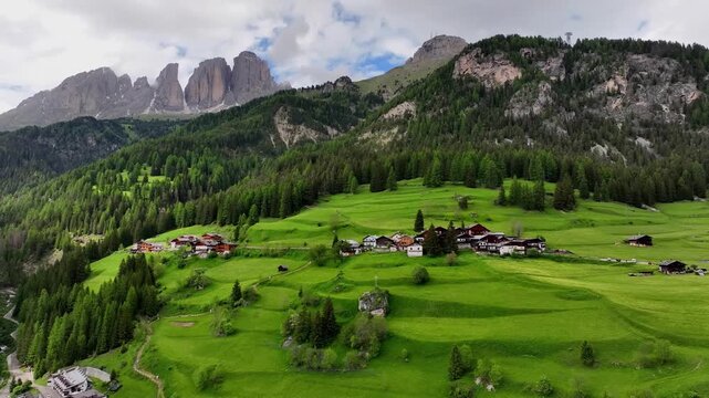 Aerial view above Val di Tires, with the Catinaccio - Torri del Vajolet Rosengarten in the background, South Tyrol, Italy