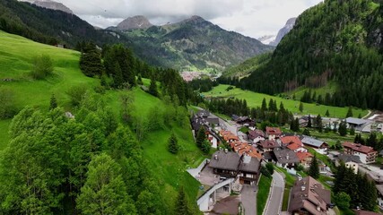 Aerial view above Val di Tires, with the Catinaccio - Torri del Vajolet Rosengarten in the background, South Tyrol, Italy