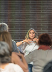 Energetic healer practicing meditation techniques with her students