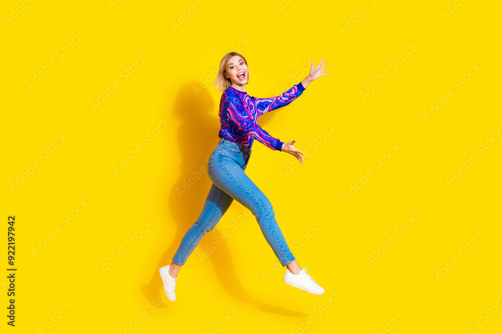 Wall mural Full size photo of pretty young girl run stretch hands want hug wear trendy colorful blue outfit isolated on yellow color background