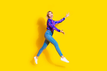 Fototapeta na wymiar Full size photo of pretty young girl run stretch hands want hug wear trendy colorful blue outfit isolated on yellow color background