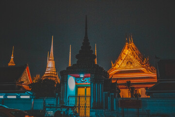 Wat Pho's pagoda-style roof and rich cultural details at night sky, evoking a sense of history and...