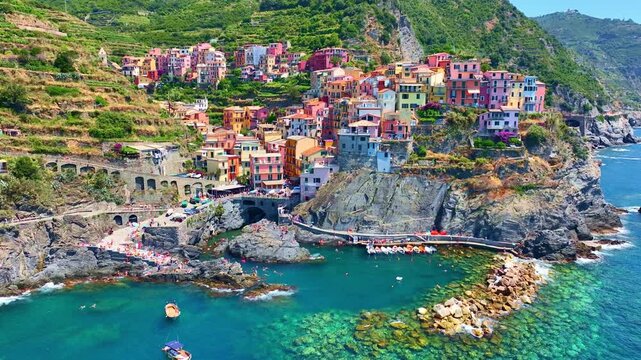 Cinque terra aerial view on a sunny day, Italian riviera, drone view of Cinque Terre, Manarola fishing village in Italy, holiday on Ligurian coast