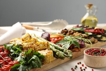 Delicious grilled vegetables with spices on white table, closeup