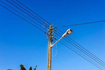 Street lamp with overhead power line in residential street in a town in the Little Karoo, Western...