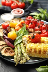 Delicious grilled vegetables on grey table, closeup