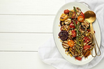 Delicious salad with grilled vegetables served on white wooden table, top view. Space for text