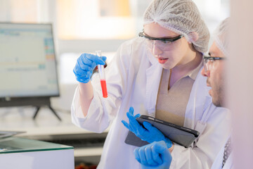 Scientists prepare for the experiment by wearing latex gloves. An experimenter arranges...
