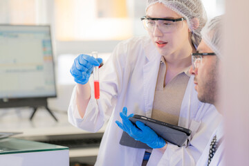 Scientists prepare for the experiment by wearing latex gloves. An experimenter arranges...