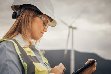 In the field of wind energy, professionals utilize advanced technology to monitor turbine performance conveniently using a tablet, ensuring efficiency and reliability in renewable energy production