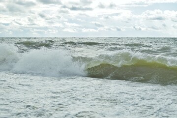 Big waves in the sea. Beautiful sea with splashes under the bright morning sunlight.