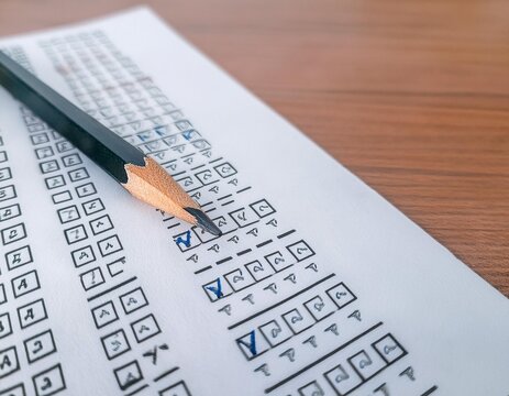 Test and examination materials featuring elements like a pencil, paper, and checkmarks representing assessment, education, and evaluation.