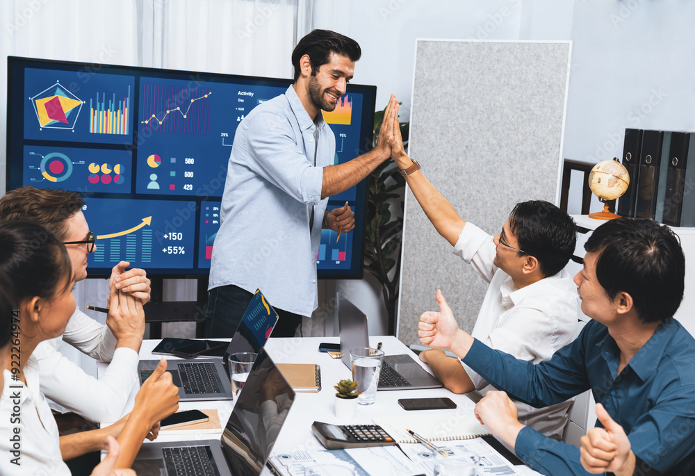 Leinwandbilder Analyst team leader celebrate and high five together with his colleague after successful data analysis meeting using FIntech software power with business intelligence or BI dashboard. Prudent