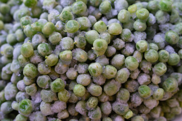 Frozen green peas close-up. Peeled green pea beans during long-term storage