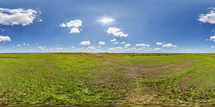 spherical 360 hdri panorama among green farming field with clouds on blue sky in equirectangular seamless projection, use as sky dome replacement, game development as skybox or VR content