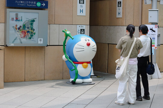 TOKYO, JAPAN - August 14, 2024: A large model of the character Doraemon in front of a map at the Roppongi Hills complex.