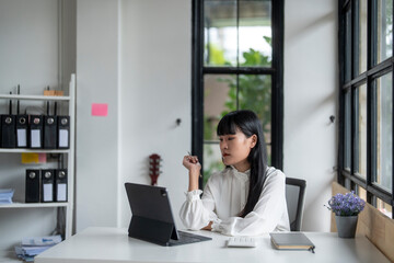 Businesswoman working on digital tablet in modern office