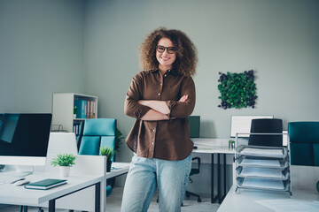 Photo of cheerful lovely charming successful woman working in new office comfortable space indoors