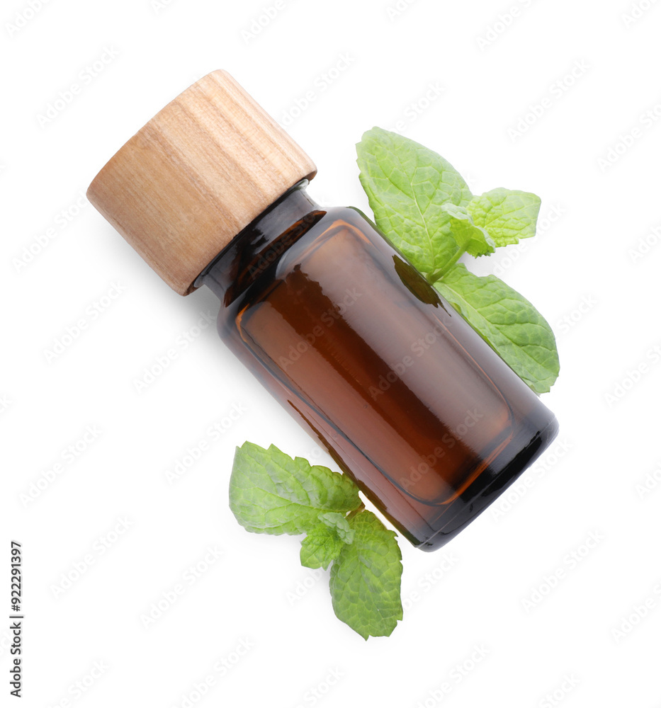 Wall mural bottle of essential oil and mint isolated on white, top view