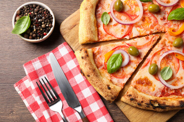 Delicious vegetarian pizza served on wooden table, flat lay