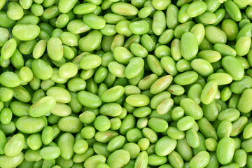 Raw green edamame soybeans as background, top view