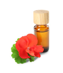 Bottle of geranium essential oil and beautiful flower isolated on white