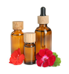 Bottles of geranium essential oil and beautiful flowers isolated on white