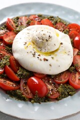 Fresh delicious burrata salad on table, closeup