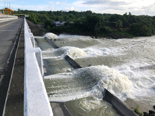 Swirling water waves coming from the irrigation dam spillway