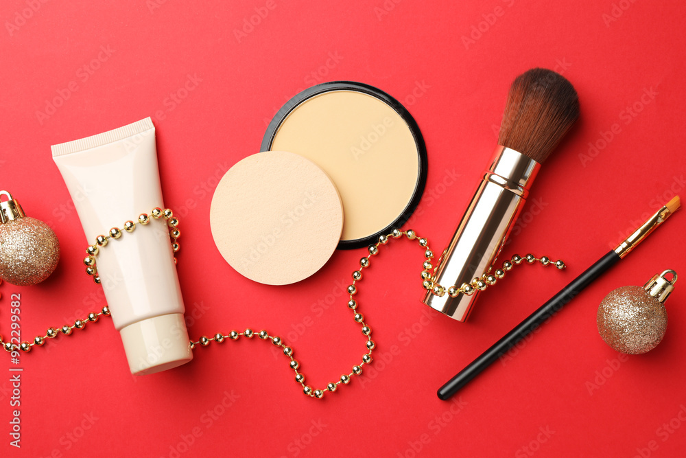 Wall mural flat lay composition with makeup products and christmas decor on red background